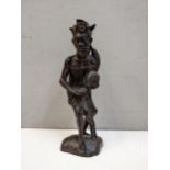 Carved wooden figure of an Indonesian tribesman with cockerel, 42cm high Location:
