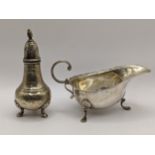 An early 20th century silver sauce boat, together with a silver pepper shaker, 104.5g, Location: