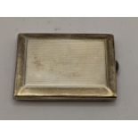 A 1920s silver vesta case having engine turned decoration and inscription to the inside,