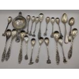A selection of white metal continental cutlery to include a tea strainer spoon, total weight 210.6g