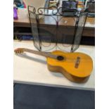 A Estrada acoustic guitar together with a small folding fine surround Location: