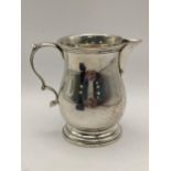 An early 20th century silver cream jug, hallmarked London 1903 84.9.g, Location
