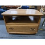 An Ercol light elm Windsor TV cabinet having a single drawer and fall down corner flap, 48.5cm h x