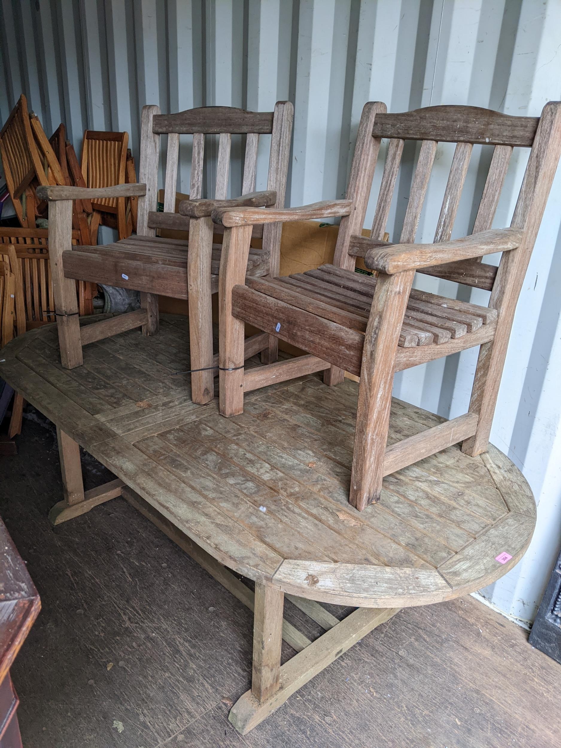 A garden Elite teak D end dining table, 70h x 218.5w, together with four matching chairs and a