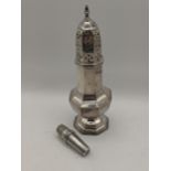 A silver needle case with engine turned detail, together with a silver plated sugar caster,