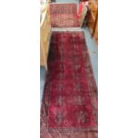 Two 20th century red ground rugs to include a runner, 180cm x 95cm and 240cm x 80cm, Location: RAM