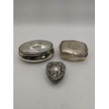 Silver trinket boxes on in the form of a heart having an embossed floral design and two others,