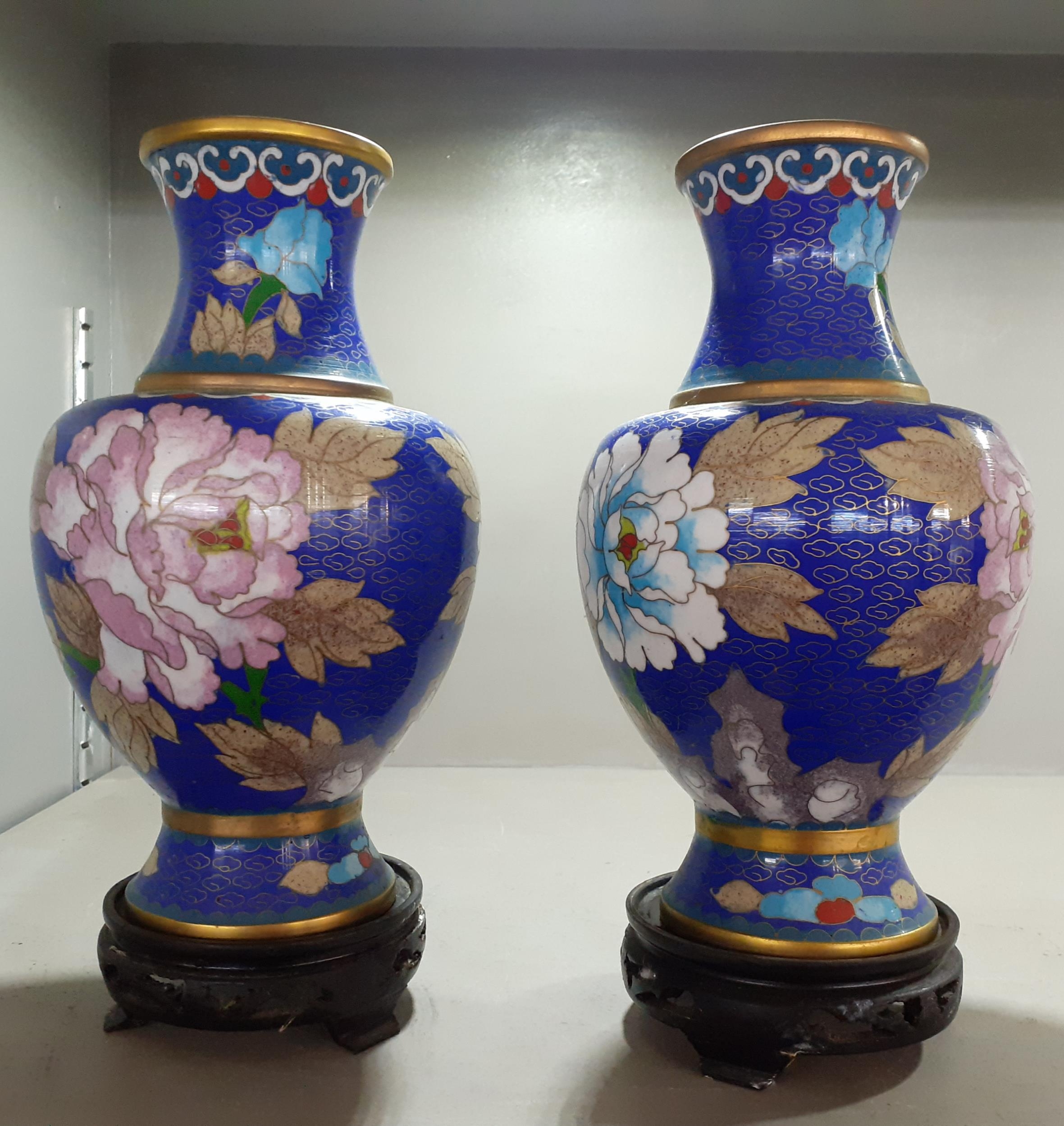 A pair of 20th century Chinese blue cloisonne vases, having treen cared stands Location:
