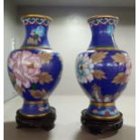 A pair of 20th century Chinese blue cloisonne vases, having treen cared stands Location: