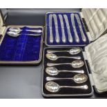 A set of six silver coffee spoons, 50.5g and silver handled knives along with other flatware