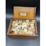 An early 20th century cased set of bone and other scrabble pieces Location: