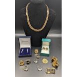 A mixed lot of costume jewellery to include gold plated horse shoe cufflinks, and others and a