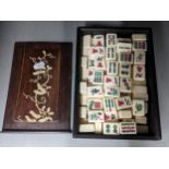 An early/mid 20th century boxed Mah Jong set, the box having bone inlaid fashioned as branches