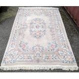 A Chinese rug having a central motif and a floral design, 250cm x 171cm Location: