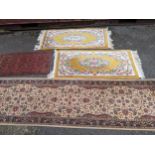 Four mixed rugs to include a pair of Chinese yellow ground rugs, 128cm x 61cm, an Indian beige