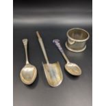 A mixed lot of silver to include two silver teaspoons, a silver marrow scoop and a silver napkin