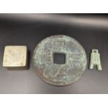 Two Chinese tokens to include a large example with square shaped hole and raised character marks,