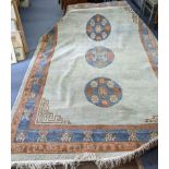 A handmade Chinese carpet with geometric motifs in pastel colours Location: