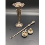 A silver weighted vase, London 1918, together with a silver handled button hook, and white metal