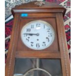 A 1930's oak cased wall clock