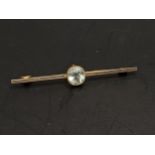A 15ct gold bar brooch inset with a faceted cut stone, possibly an aquamarine, 2.9g Location: