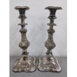 A pair of 19th century silver plated candlesticks having scroll and vine decorated columns Location: