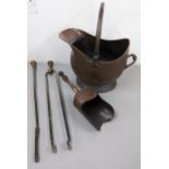 A Victorian copper coal skuttle, shovel and fire irons Location:
