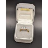 A yellow metal ring set with opals, tested as 18ct, total weight 2.0g Location: