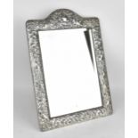 An Edwardian silver mounted dressing table mirror, Birmingham 1904, the frame with embossed c-