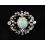 An Edwardian diamond and opal brooch, designed with pierced scrolls, set with forty-four old cut
