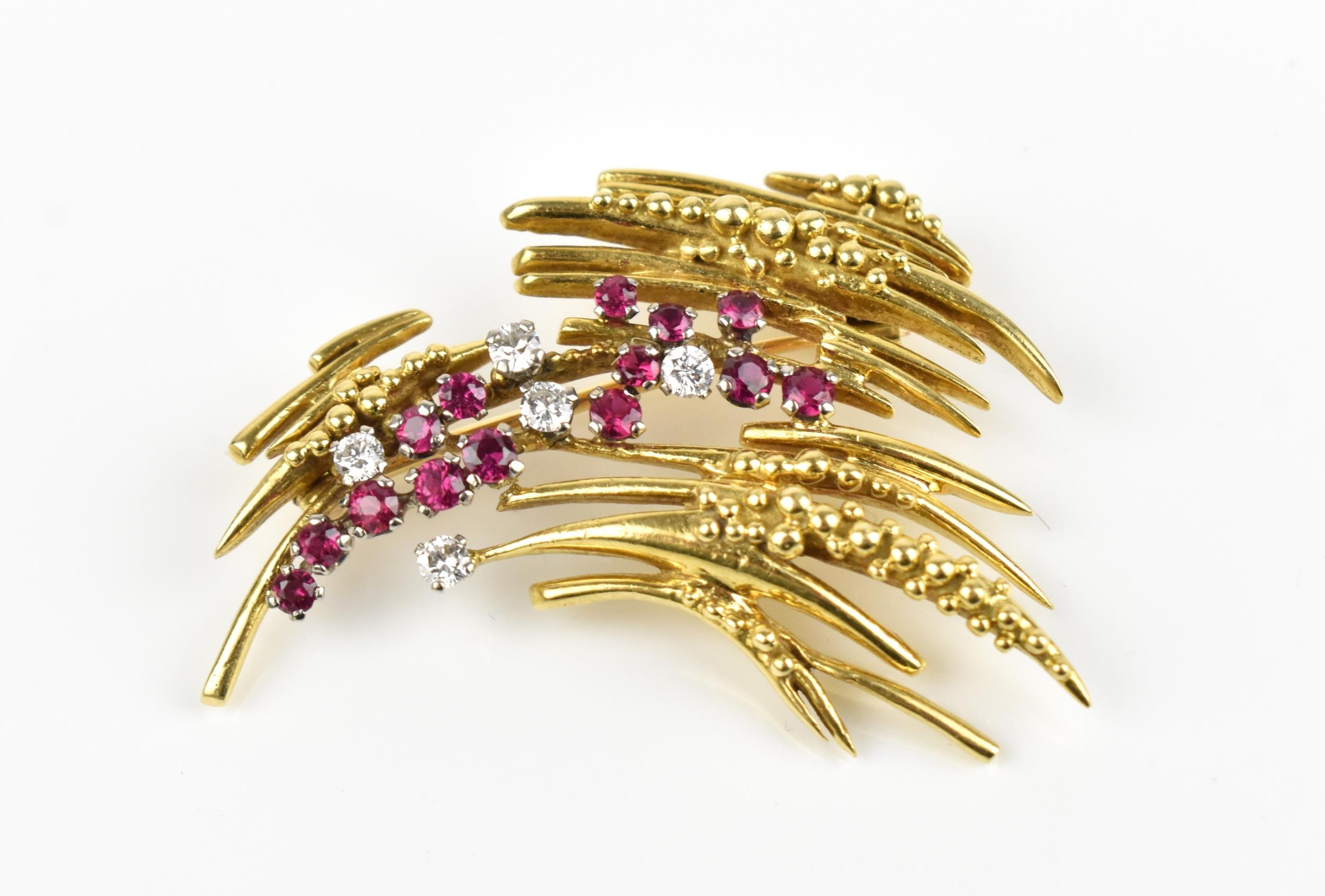 An 18ct yellow gold, diamond and ruby brooch, in the Modernist taste, set with five brilliant cut