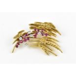 An 18ct yellow gold, diamond and ruby brooch, in the Modernist taste, set with five brilliant cut