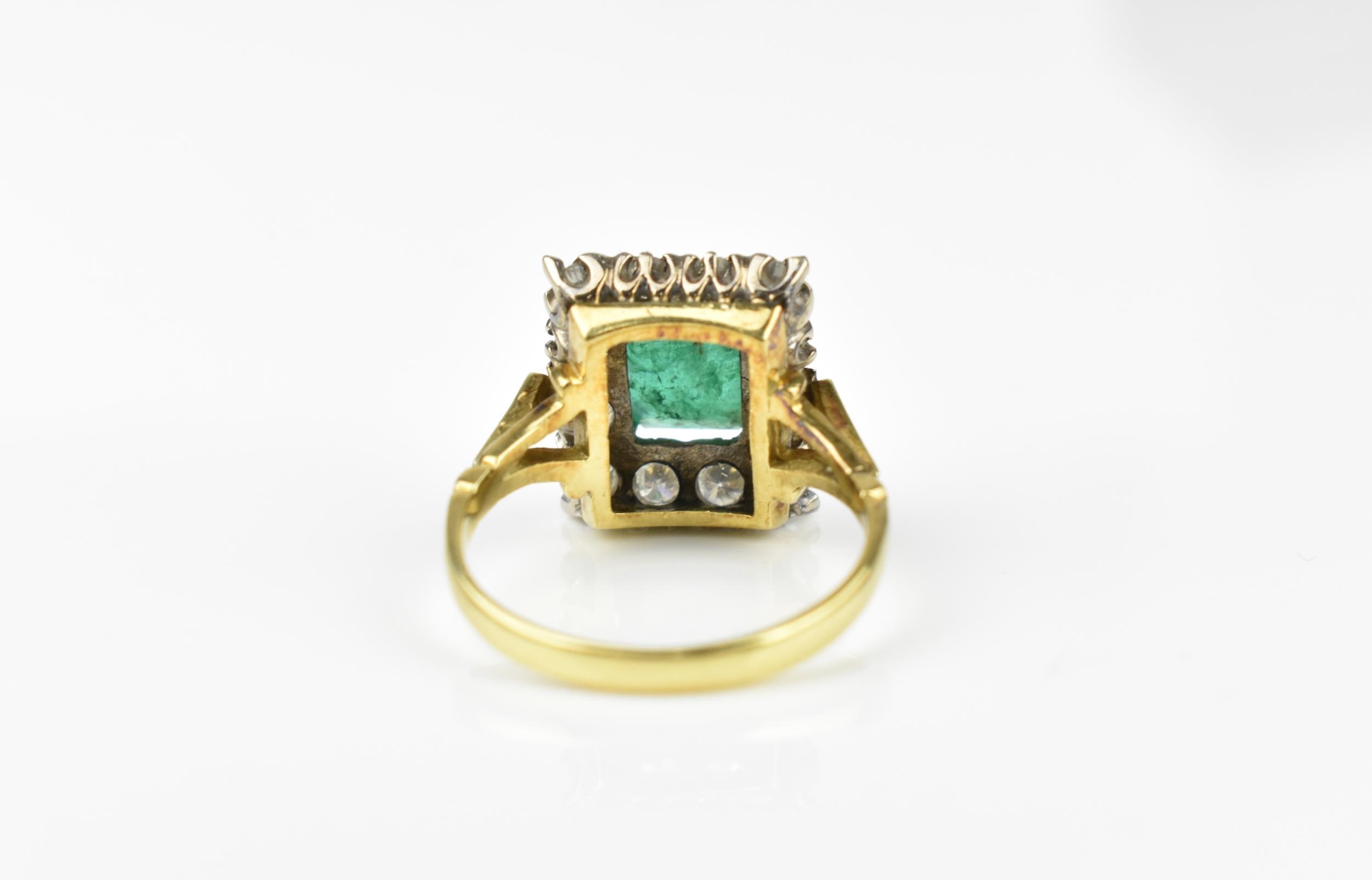 An 18ct yellow gold, emerald and diamond dress ring, with central step cut emerald in a halo of - Image 3 of 11