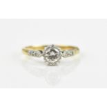 An 18ct yellow gold and platinum diamond engagement ring, with central brilliant cut diamond in