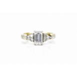 An 18ct yellow gold and diamond engagement ring, with central emerald cut diamond approx. 1ct,