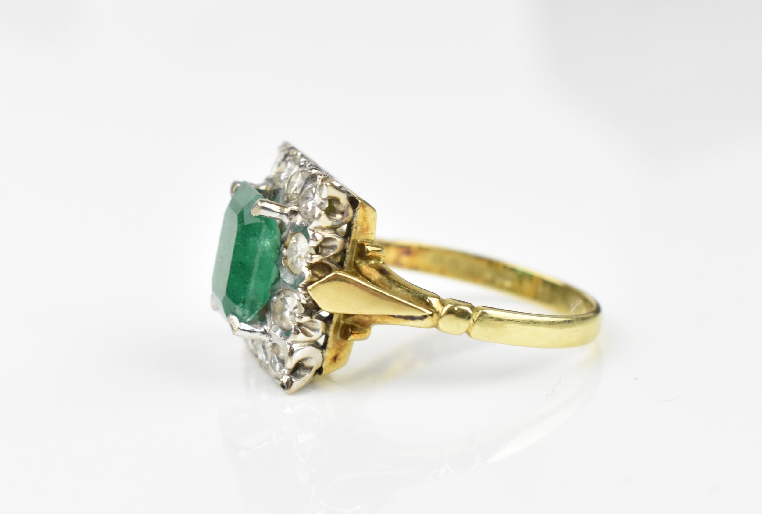 An 18ct yellow gold, emerald and diamond dress ring, with central step cut emerald in a halo of - Image 2 of 11