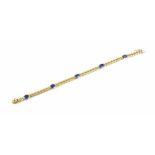 An Italian 18ct yellow gold and blue sapphire bracelet, set with five oval cut sapphires in rub-over