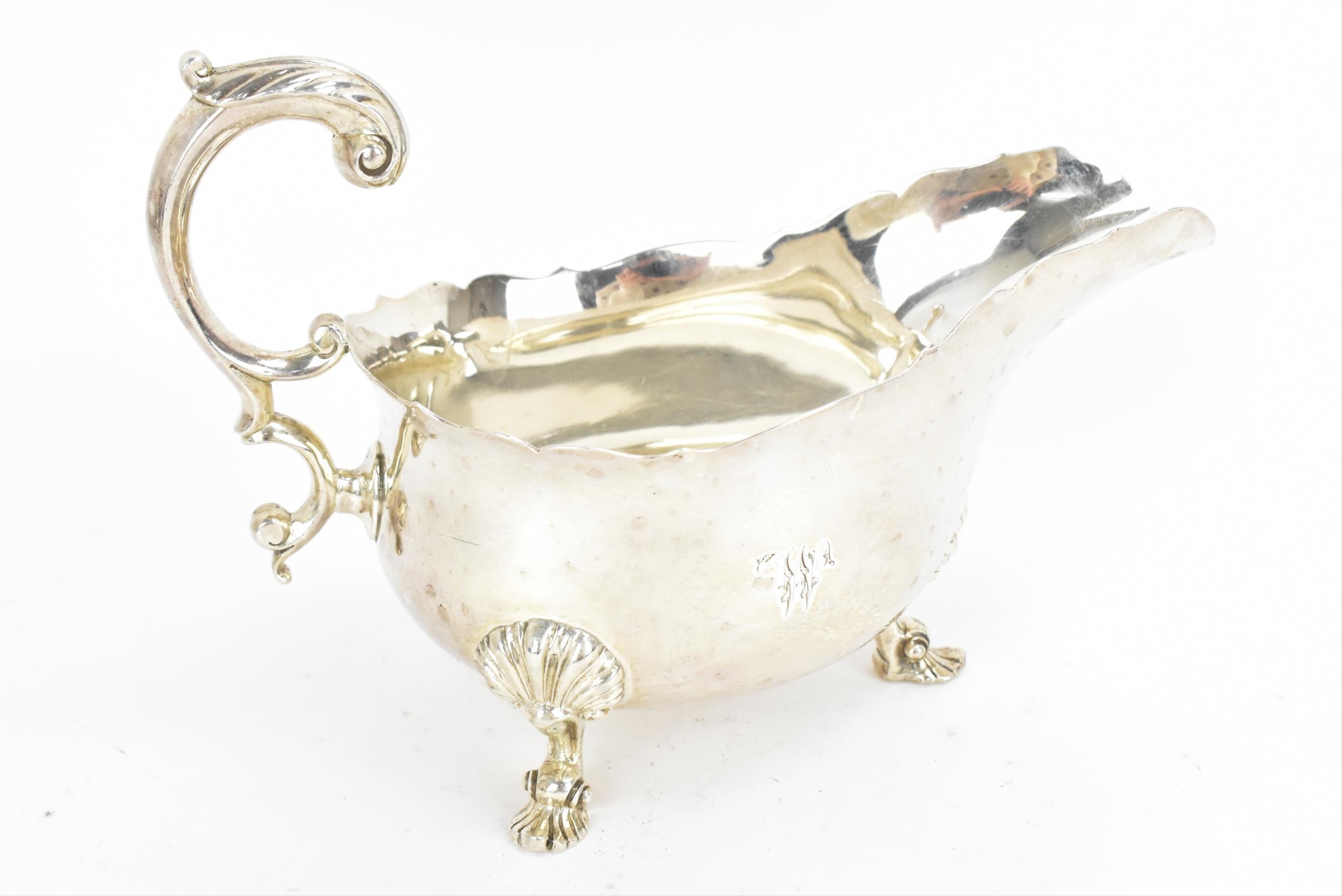 A large George III silver sauce boat by Robert Garrard II, London 1825, with pinched rim and c-