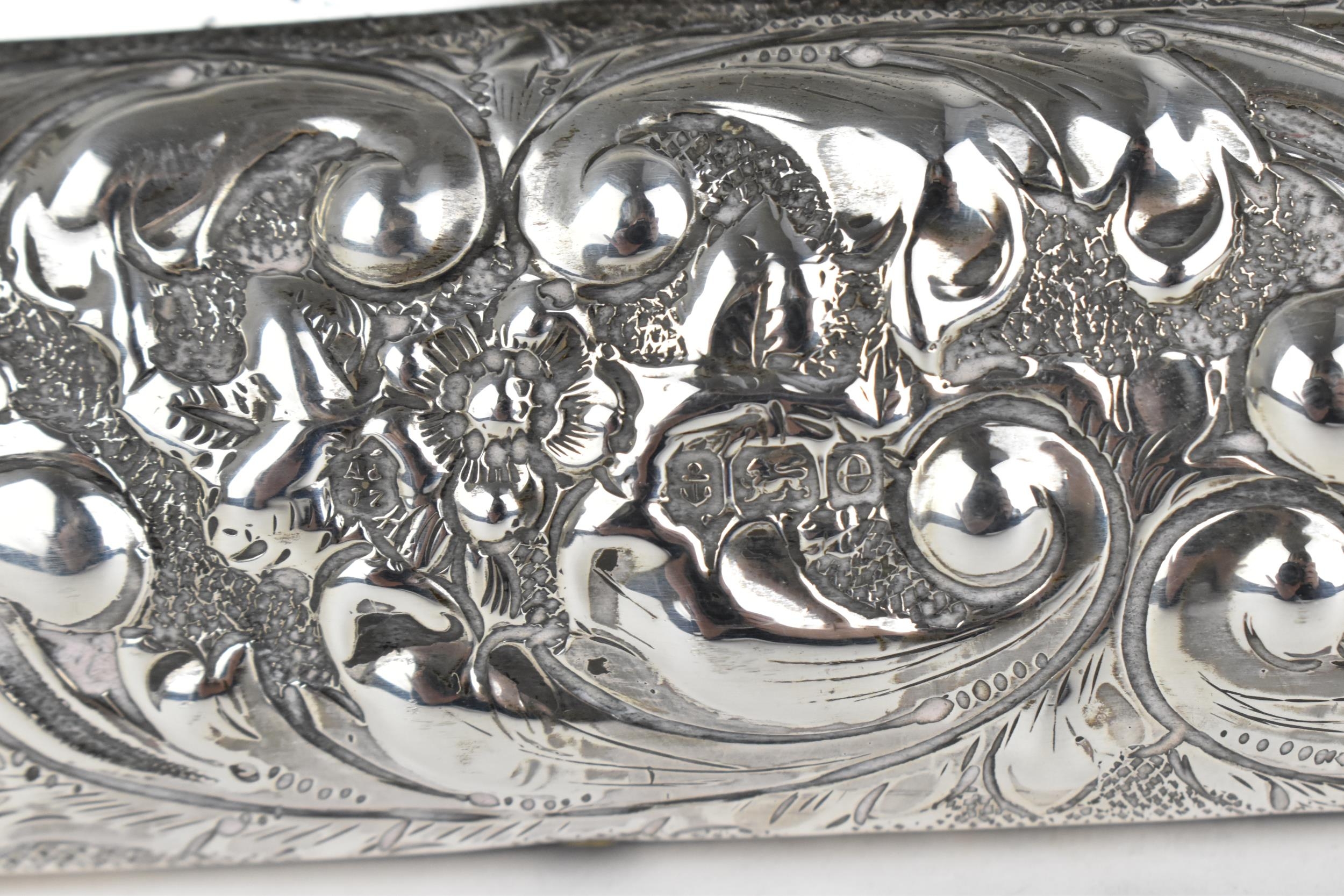 An Edwardian silver mounted dressing table mirror, Birmingham 1904, the frame with embossed c- - Image 7 of 9