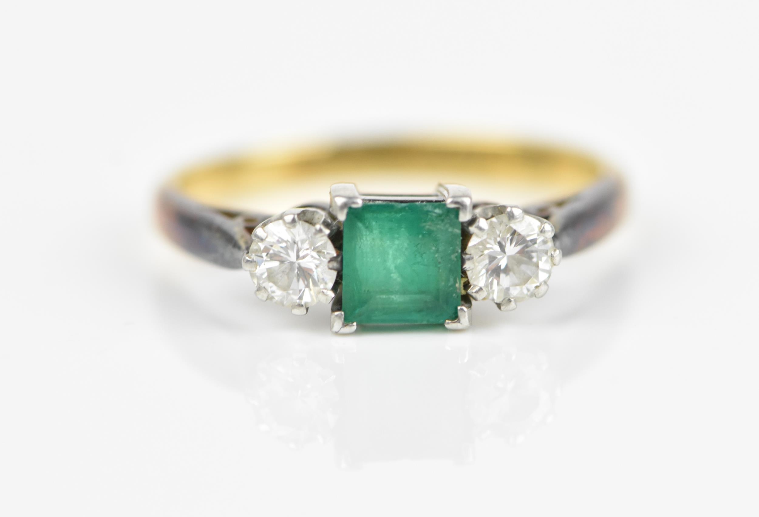 An 18ct yellow gold, platinum, emerald and diamond ring, with central princess cut emerald,