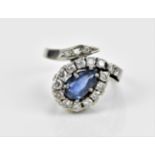 A 14ct white gold, diamond and sapphire dress ring , with central pear cut sapphire in six claw