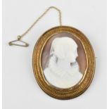 A late Victorian yellow metal mounted shell cameo brooch, carved to depict Mary Queen of Scots, with