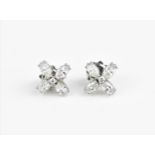A pair of 18ct white gold and diamond earrings, designed in a floral shape with four marquise cut