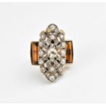 An Art Deco white, yellow metal and diamond dress ring, designed with pierced plaque centred by a