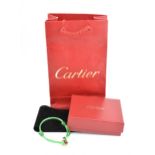 A ceramic and 18ct yellow gold 'LOVE' bracelet by Cartier, the gold loop with diamond accents, on