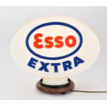 An Esso Extra plastic petrol pump globe, with light fixture, 41 cm high with base, 47 cm wide