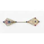 An Art Deco diamond, blue sapphire and ruby jabot pin, each end with different stone arrangement,