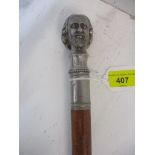 A silver plated and wooden walking cane, the handle in the form of the head of William