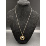 A pendant with a smokey quartz set in a 9ct gold frame on a fine chain, total 8.2g, Location: