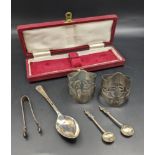 Silver to include a pair of napkin rings, two salt spoons, sugar tongs and spoon, 101g, Location: